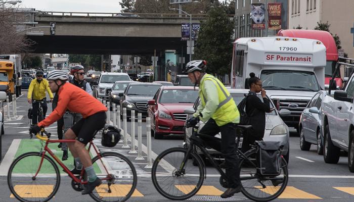 cyclists and cars at an intersection